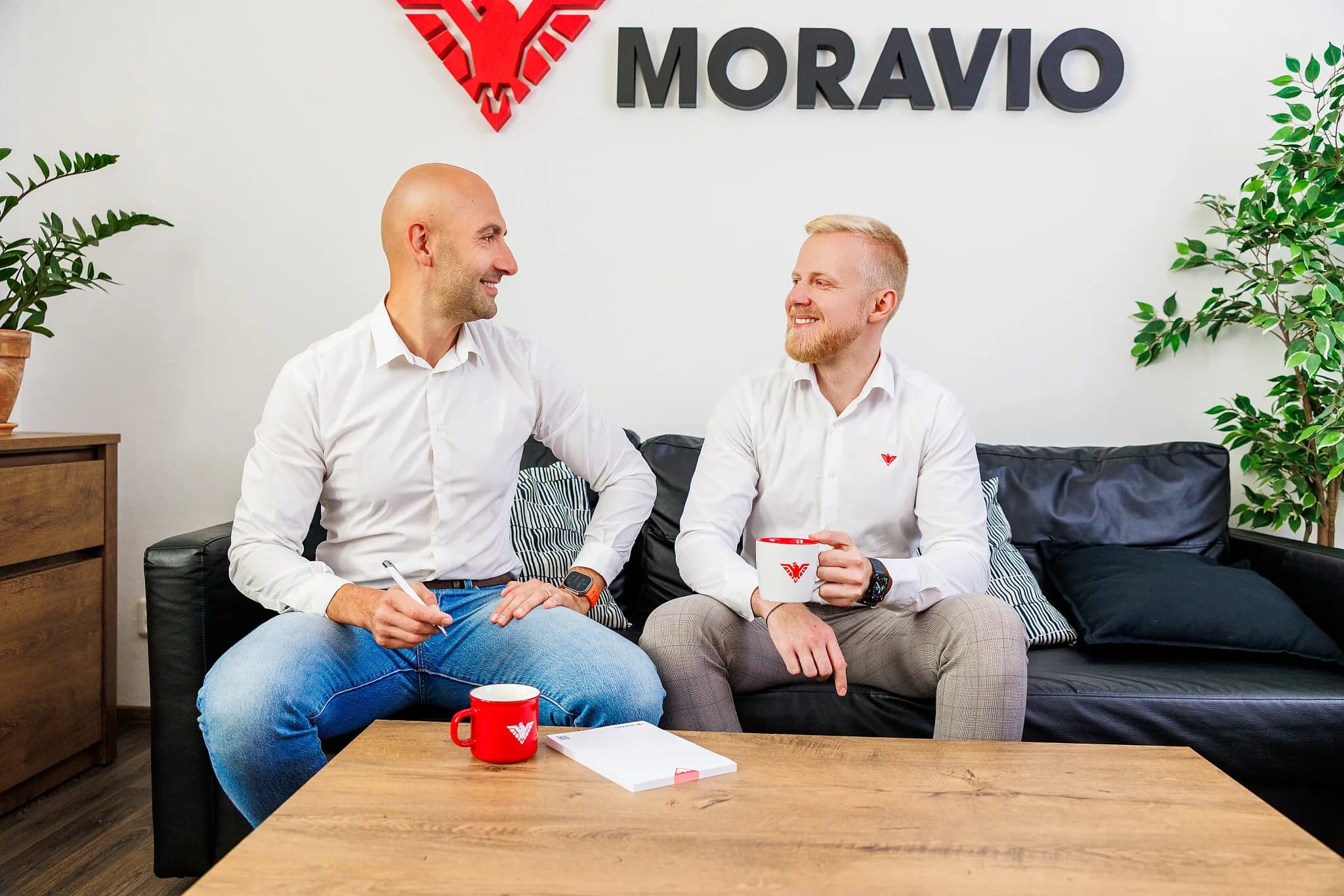 Two people from Moravio talking in the office